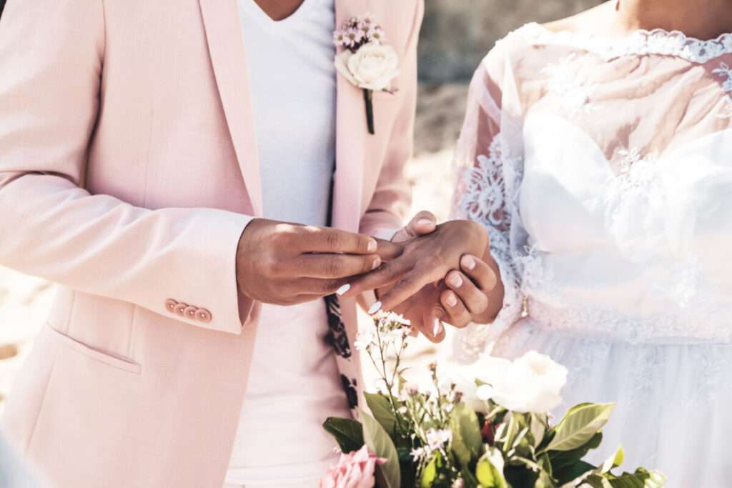 Habiller le futur marié d'un costume rose pastel pour le jour du mariage